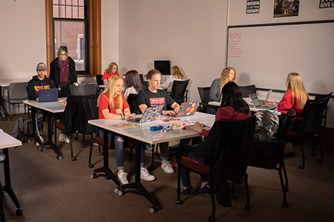 Students sitting and working in the Center for Success