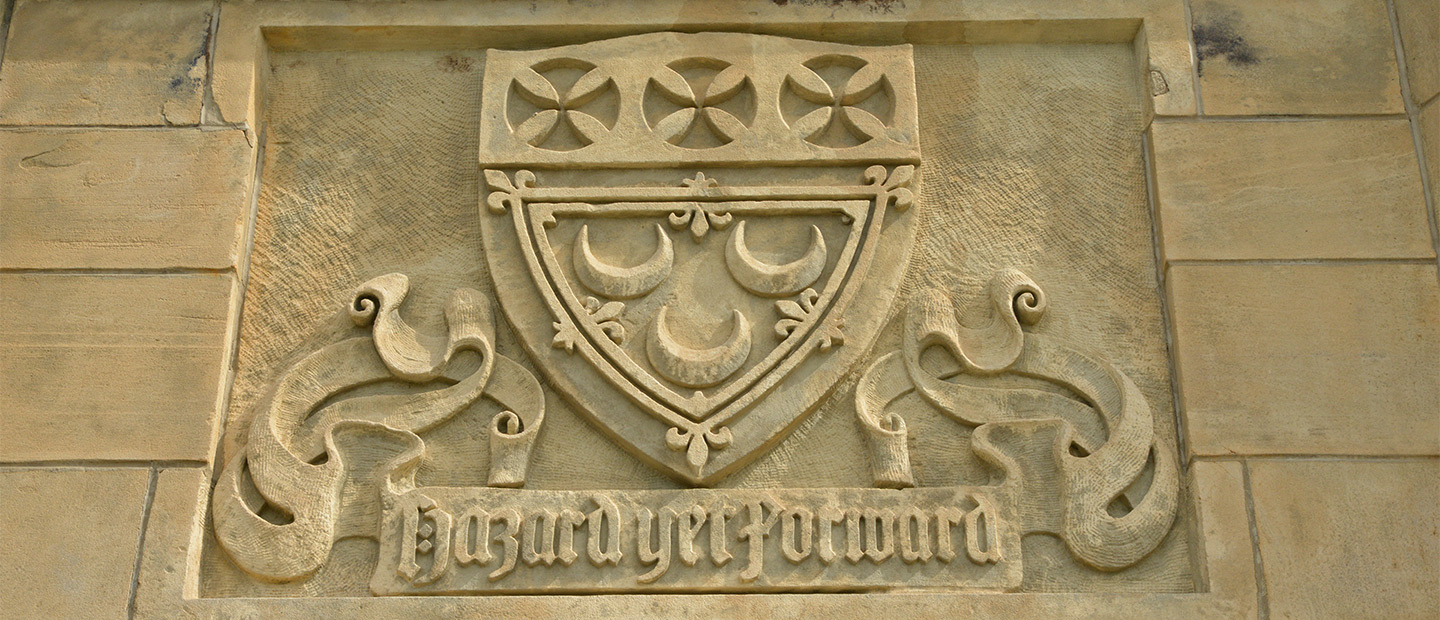 The Seton Hill crest carved in stone above the Sullivan Hall entrance.