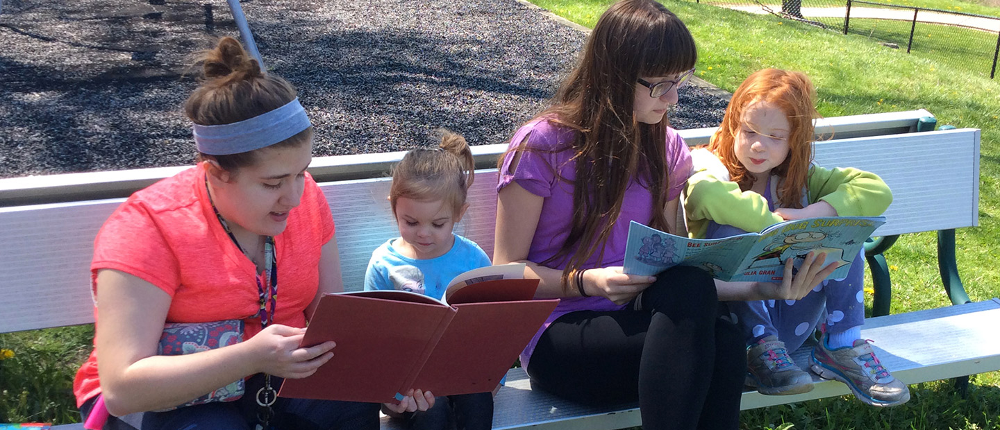 Students reading to children at the Child Development Center