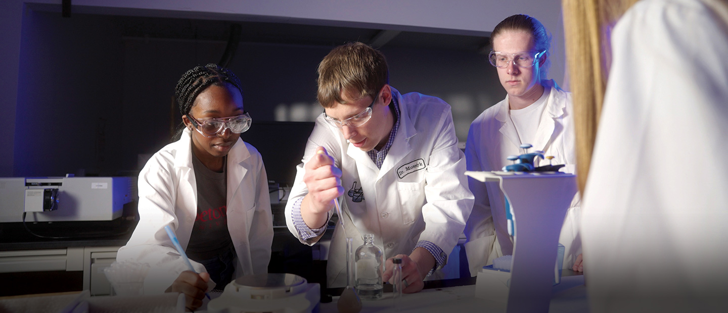 Students and their teacher in science lab