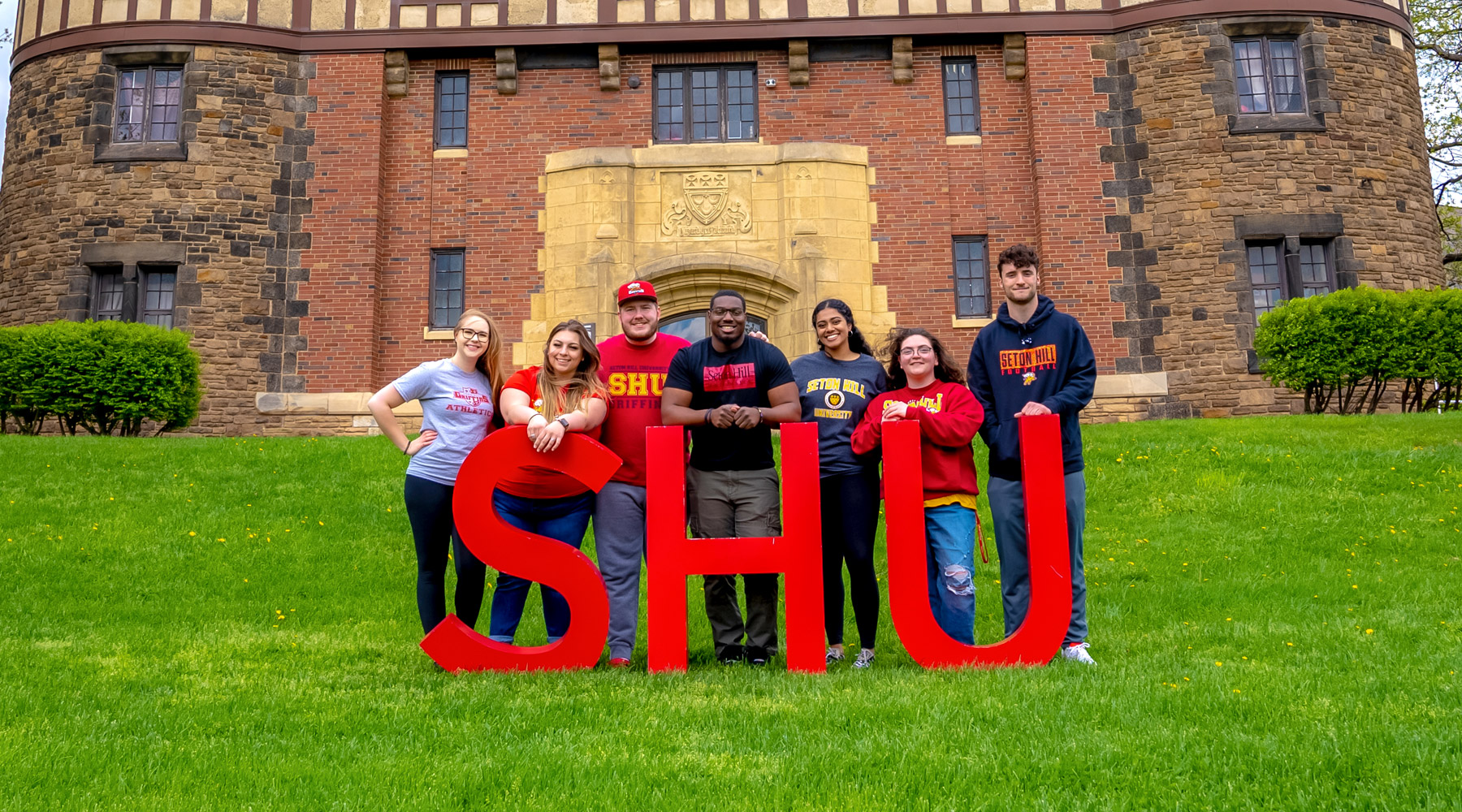 Students in front of SHU letters