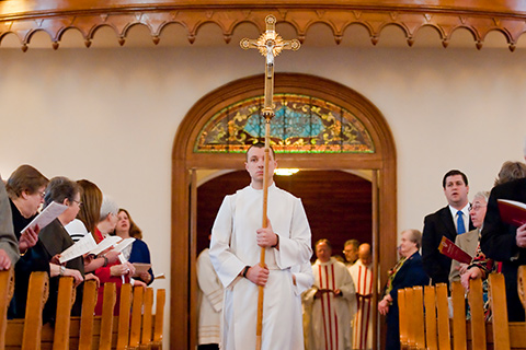 Man carrying a cross enters Saint Joseph Chapel