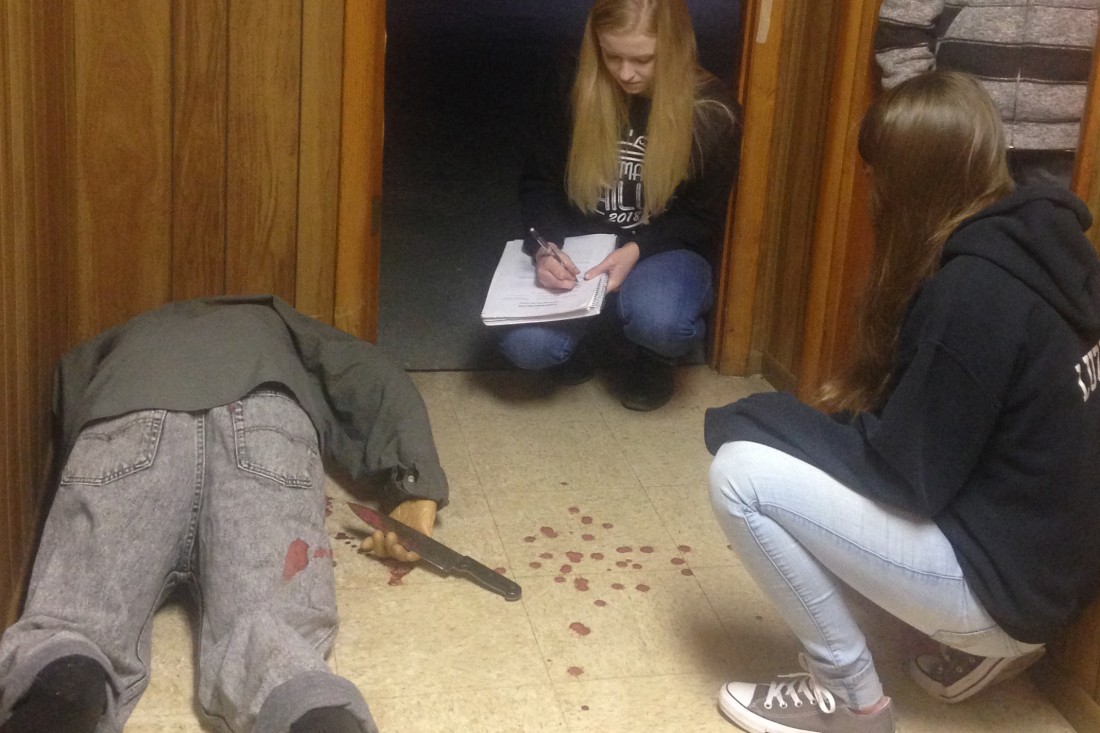 Forensic science students processing crime scene