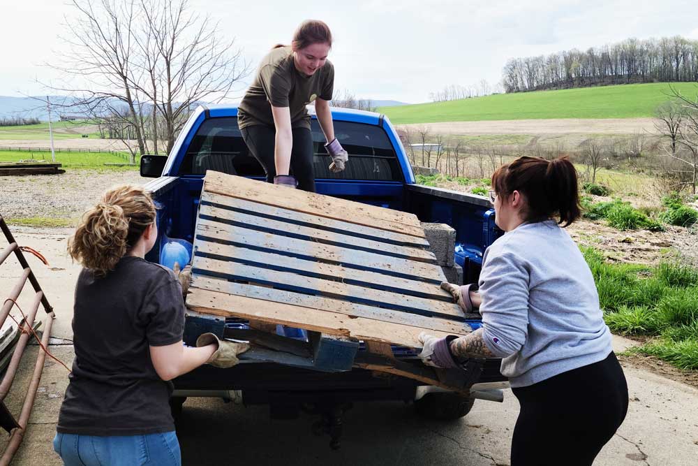 Students Moving Pallets on Earth Day of Service