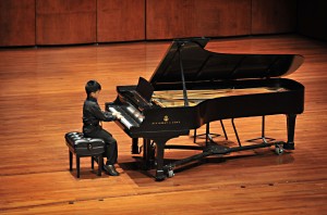 A male Community Music piano student performs in a recital