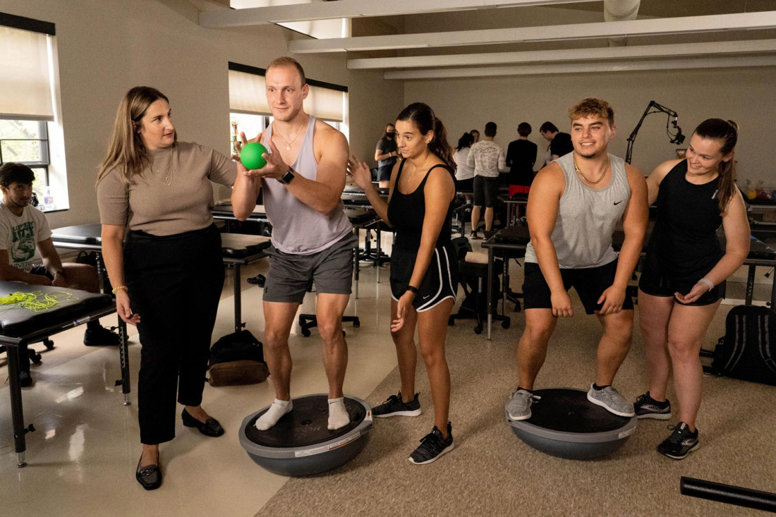 Physical Therapy students learn hands-on techniques from their professor. 