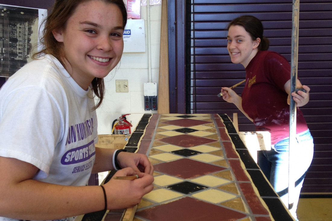 Lining grout on tile for the production of The Hollow.