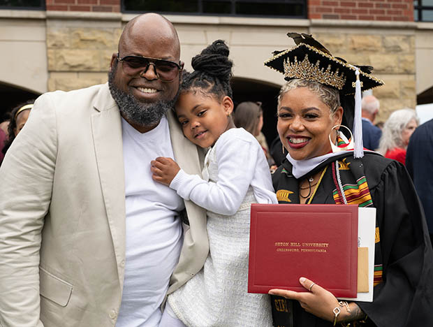 ashley hicks with her husband and daughter at commencement