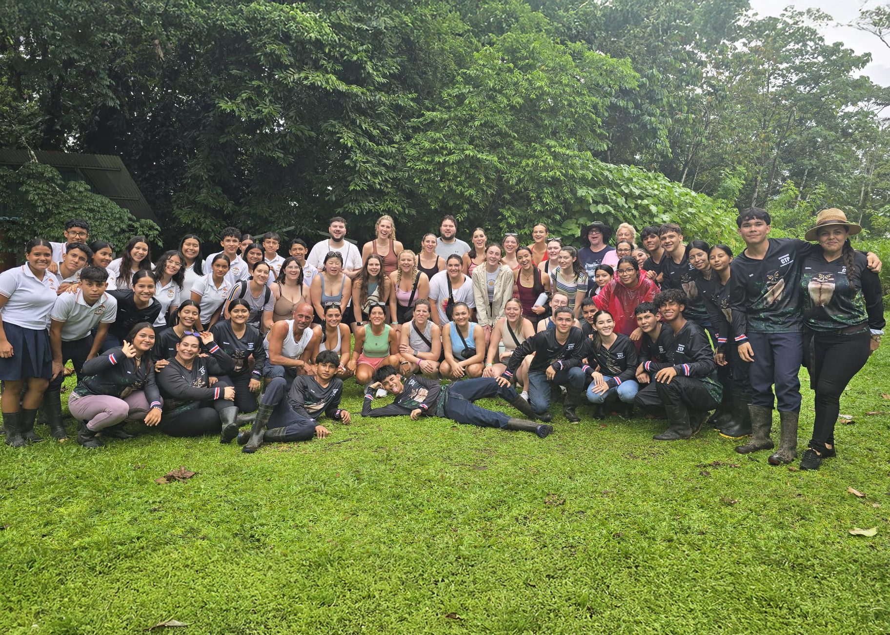 Group of people by a jungle.